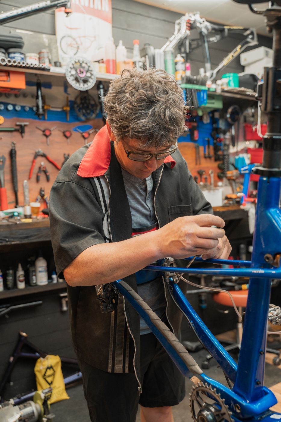 Spencer working on a bike in the service bay